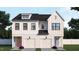 A symmetrical home showcasing a double front elevation, modern design, two-car garages, and beautiful landscaping at 925 Selby Ave, Durham, NC 27713