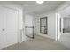 Upstairs hallway featuring neutral colors and a staircase with modern white wooden handrail at 1005 Forest Willow Ln, Morrisville, NC 27560