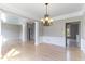 Dining room with hardwood floors, decorative chandelier, and elegant wainscoting at 101 Rock River Rd, Morrisville, NC 27560