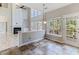 Bright dining area with a large window set, access to the deck, decorative lighting, and a view to the living room at 101 Rock River Rd, Morrisville, NC 27560