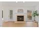 Cozy living room showcasing a fireplace with mantel, flanked by a door and window at 1010 Blackpine Ct, Knightdale, NC 27545