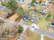 An aerial view shows a quaint neighborhood with mature trees lining the streets at 1012 E Harnett St, Dunn, NC 28334