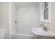 A tiled bathroom includes a shower-tub combination and sink at 1012 E Harnett St, Dunn, NC 28334