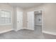 Neutral bedroom featuring gray vinyl flooring, two windows, and two closets at 1012 E Harnett St, Dunn, NC 28334