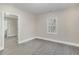 Bright bedroom with neutral walls, sleek gray flooring and natural light from the window at 1012 E Harnett St, Dunn, NC 28334