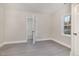 Bedroom with neutral walls, modern flooring, and doorway leading into the bathroom at 1012 E Harnett St, Dunn, NC 28334