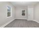 Light-filled bedroom showcasing new gray vinyl plank flooring and windows at 1012 E Harnett St, Dunn, NC 28334