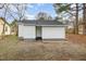 View of the back of the home, featuring neutral paint and a gray shingled roof at 1012 E Harnett St, Dunn, NC 28334