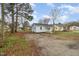 Quaint home with fresh exterior paint, a new porch, and a gray shingled roof at 1012 E Harnett St, Dunn, NC 28334