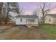 Charming single-story white house with a front porch and gray roof at 1012 E Harnett St, Dunn, NC 28334