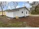 Exterior view of freshly painted home with gray shingled roof and new backyard door at 1012 E Harnett St, Dunn, NC 28334