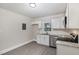 Bright kitchen with stainless steel appliances, granite countertops, and white cabinets at 1012 E Harnett St, Dunn, NC 28334