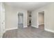 Open-concept living room with sleek flooring, new paint, and multiple entryways at 1012 E Harnett St, Dunn, NC 28334