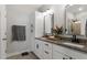 Bathroom featuring double sinks with granite countertops, framed mirrors, and white cabinets at 1014 Falling Rock Pl, Durham, NC 27703