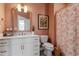 Charming bathroom with peach walls, marble countertop, and floral shower curtain at 1014 Falling Rock Pl, Durham, NC 27703