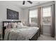 Bedroom featuring a bed, windows with blinds, and neutral decor at 1014 Falling Rock Pl, Durham, NC 27703