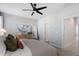 Well-lit bedroom features a ceiling fan, art, and a neutral color scheme at 1014 Falling Rock Pl, Durham, NC 27703