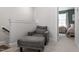 Cozy landing with a comfortable gray chair and ottoman, leading to a bedroom at 1014 Falling Rock Pl, Durham, NC 27703