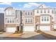 Townhome exterior with garage and brick accents is surrounded by a manicured lawn at 1014 Falling Rock Pl, Durham, NC 27703