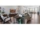 Open living space featuring a modern sofa and hardwood floors with a view into the kitchen at 1014 Falling Rock Pl, Durham, NC 27703