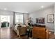 Cozy living room with modern sofas, stylish decor, and a sliding glass door to the patio at 1014 Falling Rock Pl, Durham, NC 27703