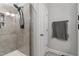 Modern bathroom shower with a rainfall shower head and tiled walls at 1014 Falling Rock Pl, Durham, NC 27703