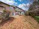 Backyard highlighting the exterior of the home with yard space and wooded areas, backing up to trees at 102 Forrymast Trl, Apex, NC 27539