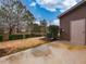 Backyard featuring a patio and a private setting with mature trees and a side entrance to the home at 102 Forrymast Trl, Apex, NC 27539