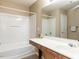 Well-lit bathroom featuring a bathtub-shower combination and a vanity with ample counter space at 102 Forrymast Trl, Apex, NC 27539