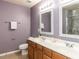Bathroom with double vanity, updated lighting, and framed mirrors at 102 Forrymast Trl, Apex, NC 27539