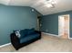 Inviting bedroom with a ceiling fan and a seating area featuring a comfortable sofa and a window at 102 Forrymast Trl, Apex, NC 27539