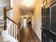 Inviting entryway with hardwood floors, staircase, and view of the living area at 102 Forrymast Trl, Apex, NC 27539