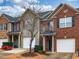 A row of townhomes showcasing varied architectural styles, with manicured lawns at 102 Forrymast Trl, Apex, NC 27539