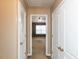 Hallway with multiple doors and neutral carpet flooring at 102 Forrymast Trl, Apex, NC 27539