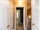 Hallway with multiple doors and neutral carpet flooring at 102 Forrymast Trl, Apex, NC 27539