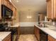 Kitchen featuring classic appliances and stylish tile backsplash with dining area view at 102 Forrymast Trl, Apex, NC 27539