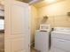 Bright laundry room featuring a washer, dryer, and shelving for organized storage solutions at 102 Forrymast Trl, Apex, NC 27539