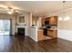 Open-concept living space featuring a fireplace, hardwood floors, and kitchen access at 102 Forrymast Trl, Apex, NC 27539