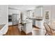 Modern kitchen featuring stainless steel appliances, a granite island, and ample cabinet space at 102 Seabreeze Ct, Cary, NC 27513