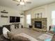 Inviting living room featuring stone fireplace, television, plush seating, and open layout at 104 Black Swan, Youngsville, NC 27596