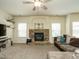 Comfortable living room showcasing a stone fireplace, TV, and a plush sectional sofa at 104 Black Swan, Youngsville, NC 27596