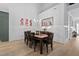 Dining room with wood table and chairs, bright chandelier, and wall decorations at 1105 Lowland St, Apex, NC 27523