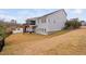 Exterior view of a well-maintained home featuring a backyard, deck, and staircase leading to the patio, ideal for outdoor living at 1105 Lowland St, Apex, NC 27523