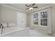 Well-lit bedroom with neutral tones, closet, and two windows with sheer white curtains at 1110 Lexington Farm Rd, Apex, NC 27502