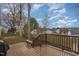 Spacious deck with wooden railings and built-in bench seating overlooking the backyard at 1110 Lexington Farm Rd, Apex, NC 27502