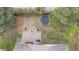 Aerial view of backyard featuring patio with fire pit, grill, trampoline, and lawn at 1117 Golden Star Way, Wake Forest, NC 27587