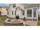 Backyard patio area with fire pit, outdoor grill, and landscaped features at 1117 Golden Star Way, Wake Forest, NC 27587