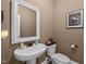 Small half bathroom with a pedestal sink, and a framed mirror at 1117 Golden Star Way, Wake Forest, NC 27587