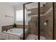 Tiled bathroom with a shower, jacuzzi tub, and a window at 1117 Golden Star Way, Wake Forest, NC 27587