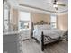 Bedroom with a wrought iron bed, wooden floors, and ample natural light at 1117 Golden Star Way, Wake Forest, NC 27587